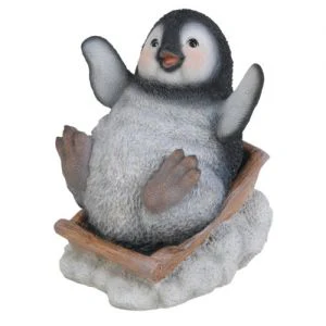Playful Sledging Penguin Christmas Ornament